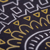 Close-up of metallic artwork on black paper created with Zart Multi Markers showing gold triangular shapes and curved lines alongside silver geometric patterns including squares and zigzag borders. The opaque, reflective ink demonstrates excellent coverage and vibrant metallic finish on dark surfaces.