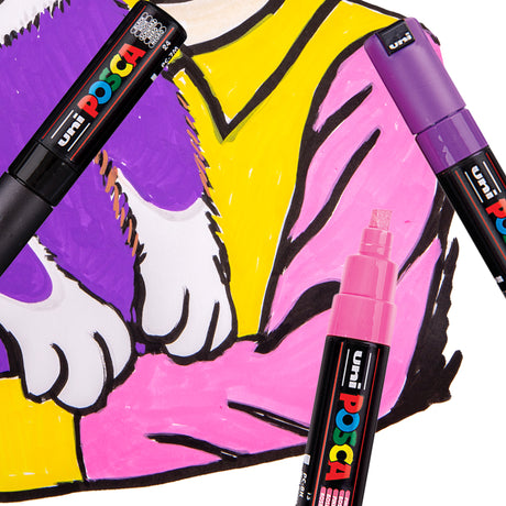 A close-up of two POSCA Chisel Tip Markers, purple and pink, resting on a colourful pop-art style drawing of a cat's paw against yellow and pink fabric. A third capped pink marker with its chisel nib visible lies in the foreground.