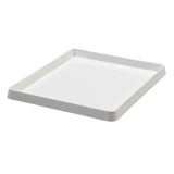 White plastic ink tray displayed at an angled perspective, showing its shallow depth and gently sloped sides. The smooth matte surface and rounded corners are visible, with raised edges forming a neat lip around the tray’s perimeter against a light grey background.