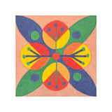 A sample artwork on a Zart Canvas Square Magnetic Board, painted as a symmetrical mandala-style design on a peach background. Blue, green, orange, yellow, and red botanical shapes radiate from a central red dot, with dotted accents, demonstrating a colourful painted technique on the canvas.