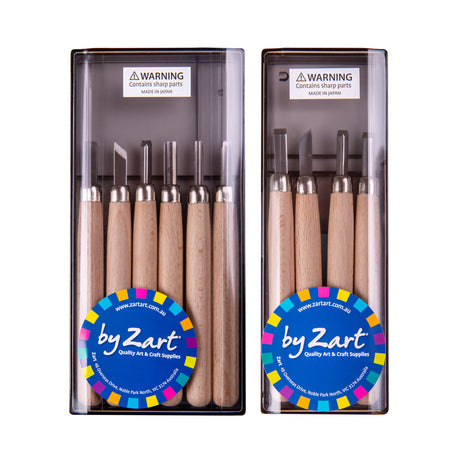 Two clear plastic cases of Zart carving tools with pale wooden handles and steel tips, displayed side by side. The left case holds six tools, the right holds four. Each carries a blue "by Zart" label and a small sharps warning notice at the top.