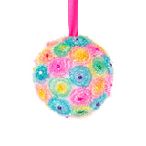 A Zart Poly Deco Foam ball decorated as a hanging bauble, covered in fluffy pastel spirals of pink, blue, green, yellow and orange, dotted with small coloured beads. It hangs from a bright pink ribbon against a white background, showing a decorative craft finish.