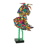 A standing bird sculpture decorated with Cardboard Mosaic Squares 2cm Pack of 4000 in a rainbow of colours outlined in black. The body and head are mosaic-covered, mounted on green pipe-cleaner legs and a black base, showing a three-dimensional craft application.