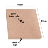 A single Zart Wooden Base shown at an angle on white, annotated with its dimensions: 9.7cm along the top edge, 9.7cm down the side, and 1.6cm high. An arrow labelled "6mm dowel hole" points to the pre-drilled hole in the centre of the natural wood surface.