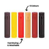 Six Ochre Slicks stand upright side by side in dark brown, yellow, red, tan, dark red and black, each with a ridged cap and base. The annotation "6 Colours" points down at the row with an arrow, while "Fast Drying & Washable" points up to the red stick specifically.