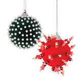 Two Zart Flocked Baubles: a green velvet bauble covered edge-to-edge in small white pearls, and a red bauble embellished with metallic red beads, pearls and faceted star-shaped gems radiating outward, giving it a spiky, decorative finish.