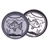 Two Mastercut Print Lino Round blocks shown with a carved fishbowl design. One block displays the completed carved lino surface, while the other shows the bold black printed result on white paper. The round format highlights how designs transfer cleanly during printing.