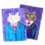 Two foam plate prints of a cat character overlap on a white background. One print is a coloured version with a blue suit jacket and bright pink tie, while the other is a darker printed version behind it. Both show etched line details defining the cat’s face and clothing.