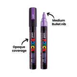Two POSCA Metallic Markers on white, one capped in violet with "Opaque coverage" annotated, the other uncapped showing its rounded metallic violet nib with "Medium Bullet nib" annotated and an arrow pointing to the tip.