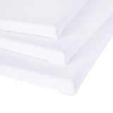Three blank Zart stretched canvases stacked at an angle, viewed from the corner to show their thin profile and depth. The white primed surface wraps neatly around each edge, with the folded corners and stapled sides visible along the stacked stretcher frames.