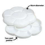 Two white plastic Zart Daisy palettes stacked diagonally, each flower-shaped with petal-style wells. Annotations read "16cm diameter" and "Two-part palette", highlighting the size and nested two-piece design that allows the trays to fit together for storage.
