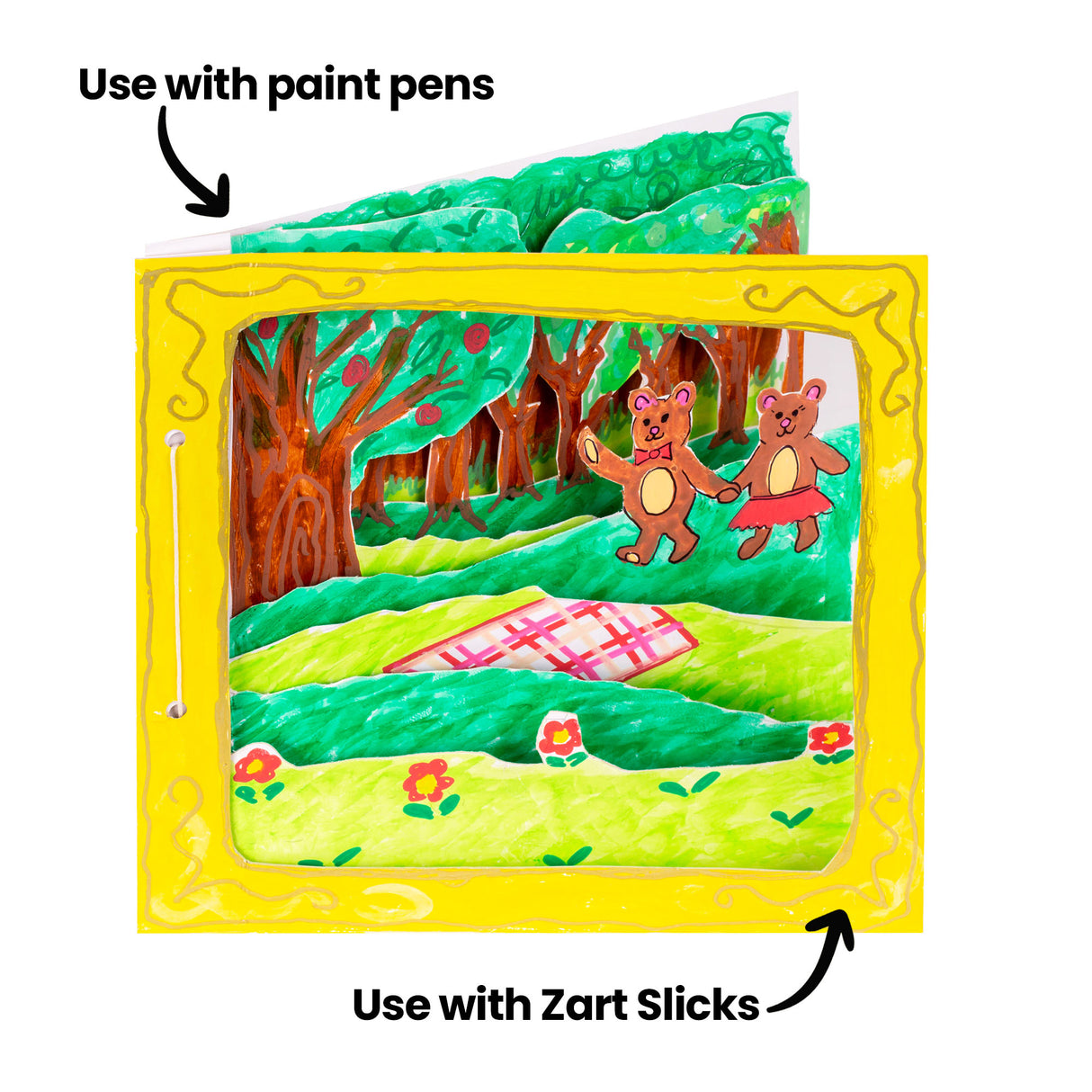 A sample artwork 3D diorama book made using Zart Card Squares White, shown from the front. A painted forest scene with two bear characters and a picnic rug sits within a yellow card frame. Two annotations read "Use with paint pens" and "Use with Zart Slicks" pointing to the artwork.