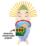 Painted mixed media face sculpture made from wooden craft sticks, featuring a stylised face with yellow stick hair and a tram scene inside the mouth, with on-image text reading “Perfect for mixed media projects.”