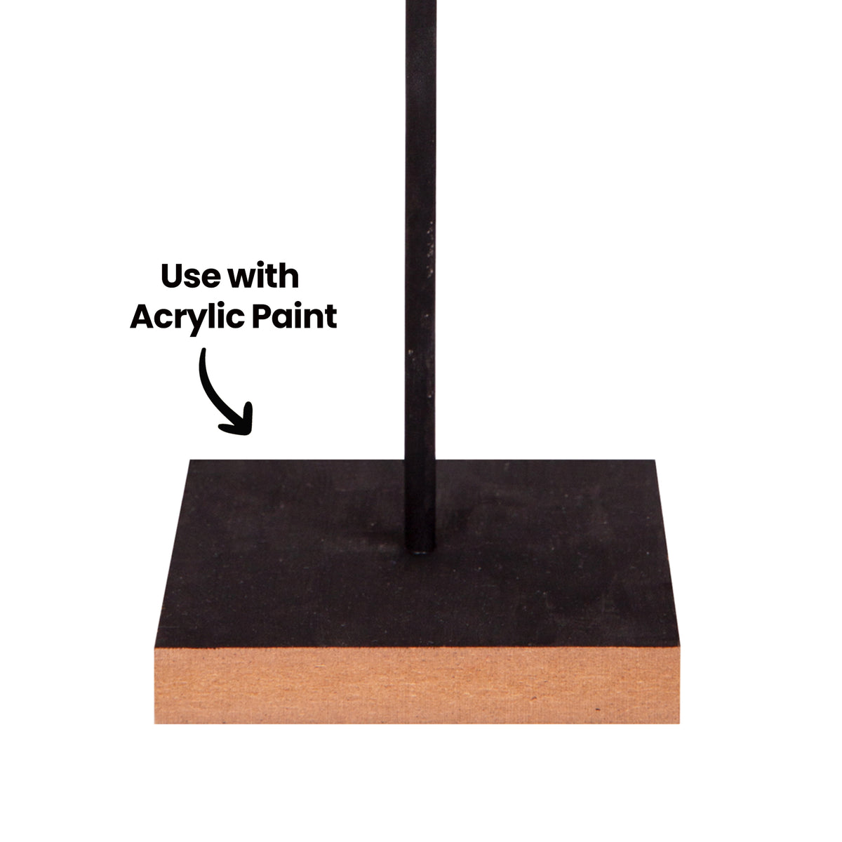 A close-up of a Zart Wooden Base with its top surface painted black and a thin black rod fixed upright through a centred hole, natural pale wood visible along the raw edge. The annotation "Use with Acrylic Paint" points to the painted top surface.