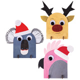 Three hand-painted samples made using Zart Desktop Message Boards, each shaped and decorated as an animal face: a blue koala in a Santa hat with felt ears, a tan reindeer with glitter antlers and nose, and a pink cockatoo with a Santa hat. All feature Joggle Eyes.