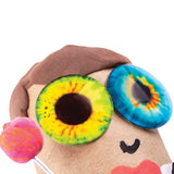 Cardboard character head with textured brown hair featuring two large dome-shaped Creature Eyes in vibrant colours: one with yellow and green iris patterns, another with blue and orange detailing. Pink pom-pom ear, black drawn smile, and red mouth accent complete the playful sculptural creation.