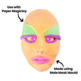 Colourful sculpted male face artwork featuring peachy-orange tones with vibrant pink lips, purple eye detail, and green accents on the forehead. Created using the Male Mask Mould with Paper Magiclay. Annotations read "Use with Paper Magiclay" and "Made using Male Mask Mould" with directional arrows.