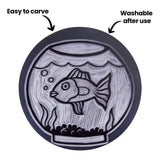 Mastercut Print Lino Round featuring a carved fishbowl design with text and arrows. Annotation reads “Easy to carve” and “Washable after use”, each pointing to the block surface. The carved grooves and raised outlines are clearly visible against the dark grey lino.