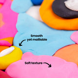 Macro close-up of Plasticine showing smooth, blended colour transitions across blue, pink, yellow and orange areas. The surface appears soft and slightly glossy with fine finger marks. Annotation text reads “Smooth yet malleable” and “Soft texture”.