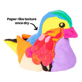 Colourful bird sculpture made from Zart Paper Magiclay Candy Colours. Annotation reads “Paper-like texture once dry,” showing smooth, layered surfaces and sculptural detail.
