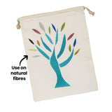 A cream cotton drawstring bag decorated with a glittering tree design in teal, with leaves in silver, gold, blue, green and pink Zart Glitter Iron-On Sheets. The annotation 'Use on natural fibres' points to a leaf, indicating the fabric type suited to application.