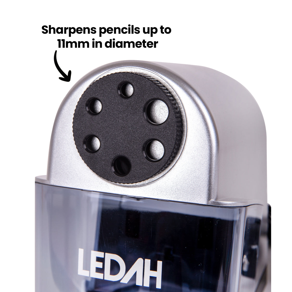 A close-up view of the Ledah Electric Pencil Sharpener focuses on the six-hole sharpening selector on the silver housing above the transparent shavings tray. Black annotation text reads “Sharpens pencils up to 11mm in diameter”, highlighting compatibility with a range of standard and larger drawing pencils.