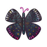 Artwork sample created with Creamy Colours Watercolours by Zart Glitter, showing a butterfly cut from black card and decorated with shimmering pink, blue, teal, silver and gold patterns. Glittering circles, lines and wing markings stand out against the dark matte surface.