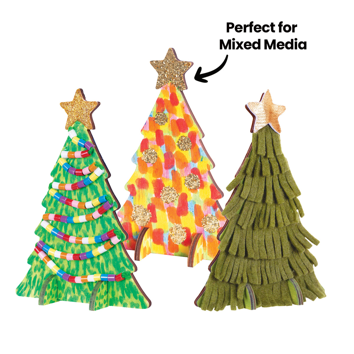Three decorated Zart Wooden Standing Tree cut-outs standing upright. One is painted green with coiled strands of colourful beads, one has bright multicoloured brushstrokes with gold glitter dots and a glittered star, and one is covered in layered olive-green felt fringing. A black arrow reads "Perfect for Mixed Media".