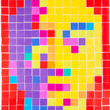 A close-up of a mosaic worked in Cardboard Mosaic Squares 2cm Pack of 4000, showing the tiles laid in a grid with small white gaps between them. Colours include red, purple, yellow, pink, blue and orange, highlighting the individual square format and matte surface.
