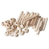 A large scattered pile of Zart Wooden Peg and Stand pieces in natural, unpainted timber. Numerous ball-topped pegs with slotted centres sit alongside loose ring-shaped stands, showing the full range of plain components included in the pack.