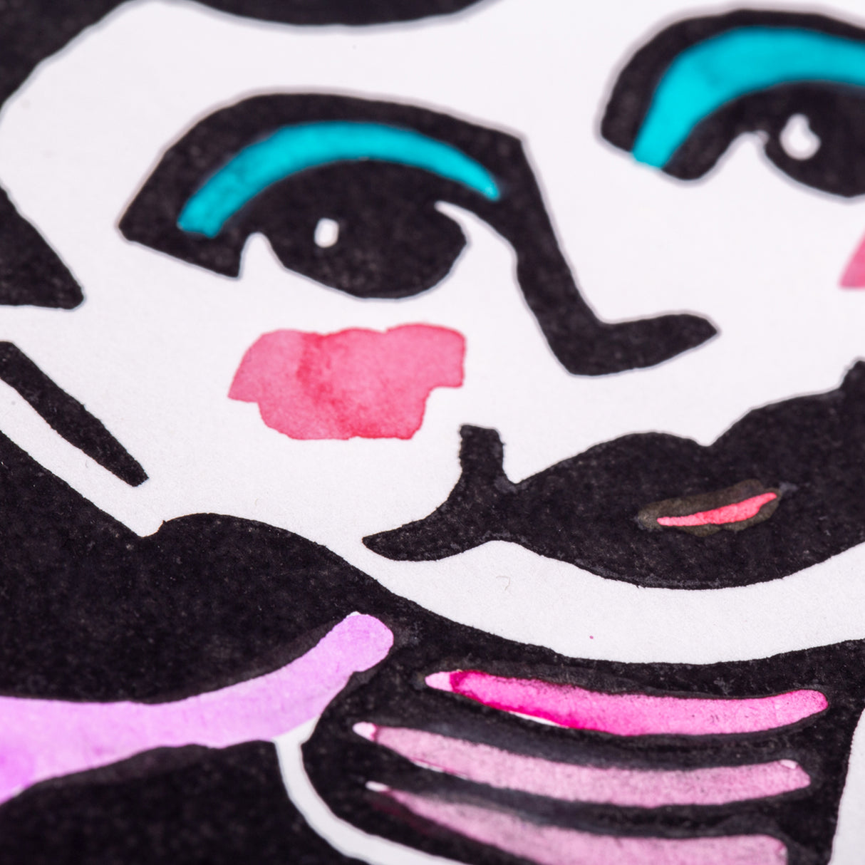 Close-up of the finished lino print showing coloured details applied to the black print, including pink and teal highlights on facial features and clothing, demonstrating how prints from the lino tile can be enhanced with additional media.