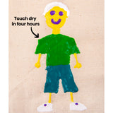 A raised puffy paint figure of a smiling person on natural calico fabric, with a yellow head and hands, white hair and shoes, purple facial features, a green top and teal shorts. Black text and an arrow read “Touch dry in four hours”, pointing toward the shoulder area.