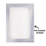 The back of a screen printing frame is shown with translucent tape covering the edges around the mesh. Black annotation text reads “Pre masked on back” with an arrow pointing to the taped border surrounding the inner screen area.