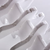 Extreme close-up of foam edges, showing a soft, slightly rough texture where cut. The surface appears matte and smooth, while the interior reveals a fine, bead-like structure with subtle shadows between the contours.