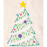A puffy paint Christmas tree design on natural calico fabric, outlined in teal with a yellow star on top. White diagonal bands represent snow across the branches, dotted with short green dashes and round pink and purple baubles scattered throughout the tree.