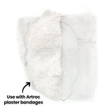 Flex-it Mesh (Medium) draped over a face mask form beneath plaster bandages, revealing layered textures. The fine diamond weave subtly shows through the matte white surface, creating a structured, contoured finish. Annotation text reads: “Use with Artroc plaster bandages”.