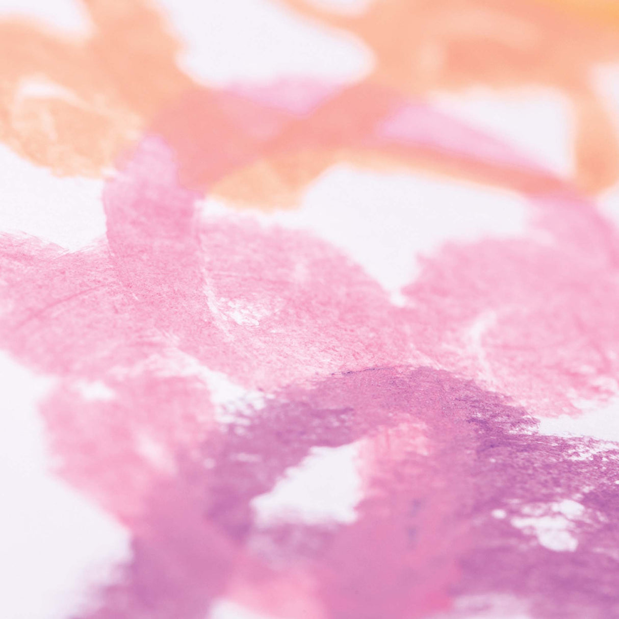 Close-up of Zart Colour Slicks marks in layered pinks, purples and peach tones. The soft, creamy texture shows how the colours blend smoothly on paper.