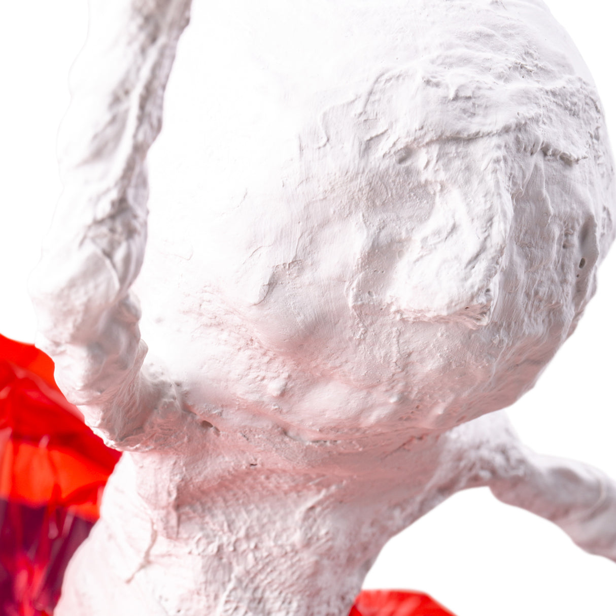 Close-up detail of a plaster bandage sculpture surface, showing layered texture and smooth dried finish, suitable for further decoration or painting.