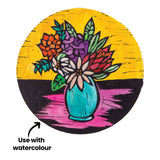 Colour artwork created from a Mastercut Print Lino Round print, featuring a vase of flowers on a bright yellow background with pink and black tabletop. Annotation text reads “Use with watercolour” with an arrow. Bold outlines show how prints can be coloured after printing.