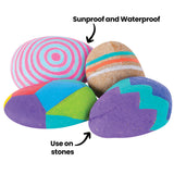 Four painted stones decorated with bright geometric and striped patterns using Street Paint Markers. Text indicates the markers are sunproof, waterproof and suitable for use on stones.