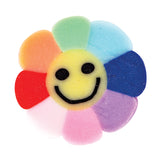 Flower-shaped silicone bead featuring eight petals in rainbow colours including orange, red, pink, purple, blue, light blue, green, and yellow. The centre petal displays a cheerful black smiley face. The textured surface has a soft, matte appearance suitable for craft and wellbeing activities.