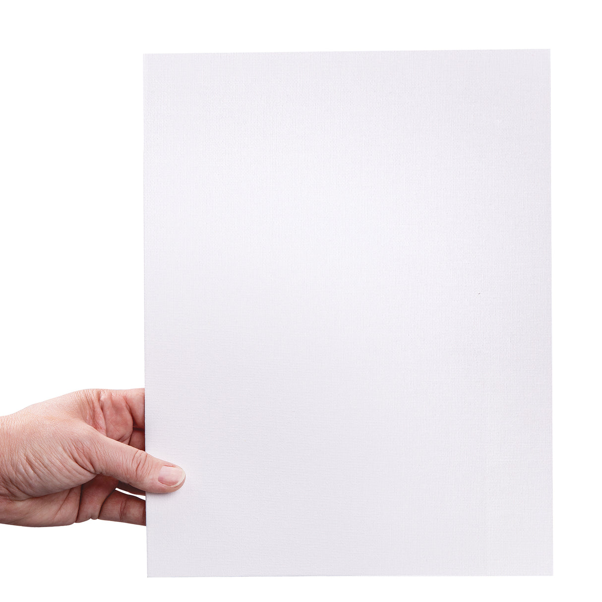 A hand holds a large canvas board upright against a pale background. The white primed canvas surface shows a fine woven texture across the board, suitable for painting and mixed media. The board appears thin with firm straight edges.