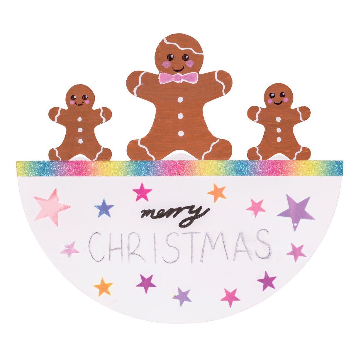 A hand-decorated Zart Rocking Christmas Card featuring a gingerbread family — one large and two small figures with white icing details — standing along a rainbow glitter edge. Below, "merry Christmas" is handwritten among pink, purple and orange foil stars scattered across the white card.