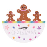 A hand-decorated Zart Rocking Christmas Card featuring a gingerbread family — one large and two small figures with white icing details — standing along a rainbow glitter edge. Below, "merry Christmas" is handwritten among pink, purple and orange foil stars scattered across the white card.