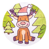A hand-illustrated sample made using a Zart Magnetic Canvas Board Round, featuring a smiling brown reindeer in a red and white Santa hat, seated among green pine trees. Pink cheeks and a soft pink nose add warmth, painted in bold outlined colour against a white background.