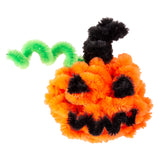 Fluffy chenille stems craft project displaying a Halloween pumpkin with jack-o-lantern face in vibrant orange, red and black, plus a black cat figure and wavy green snake or vine. The textured pipe cleaners showcase dimensional crafting possibilities in seasonal colours.