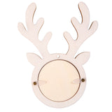 Flat lay of a wooden reindeer-shaped frame crafted from light natural plywood. The decorative piece features branching antlers, pointed ears, and a circular cutout in the centre secured with two small brass screws, ideal for inserting photos or artwork. A small hole at the top allows for hanging.