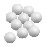 Ten Zart Poly Deco Foam balls gathered in a loose arrangement against a white background. Each smooth white sphere shows the lightly dimpled, beaded foam texture across its surface, with a faint moulding seam running around the middle of each ball.