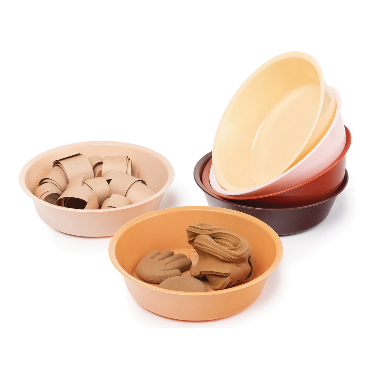 Six shallow sorting bowls in warm earth tones including cream, pale pink, peach, orange, terracotta and brown, arranged in a stack and displayed individually. Two bowls contain natural clay pieces including cylindrical tubes, hand shapes and oval forms, demonstrating the bowls' use for organising and sorting art materials in Friendship Colours.