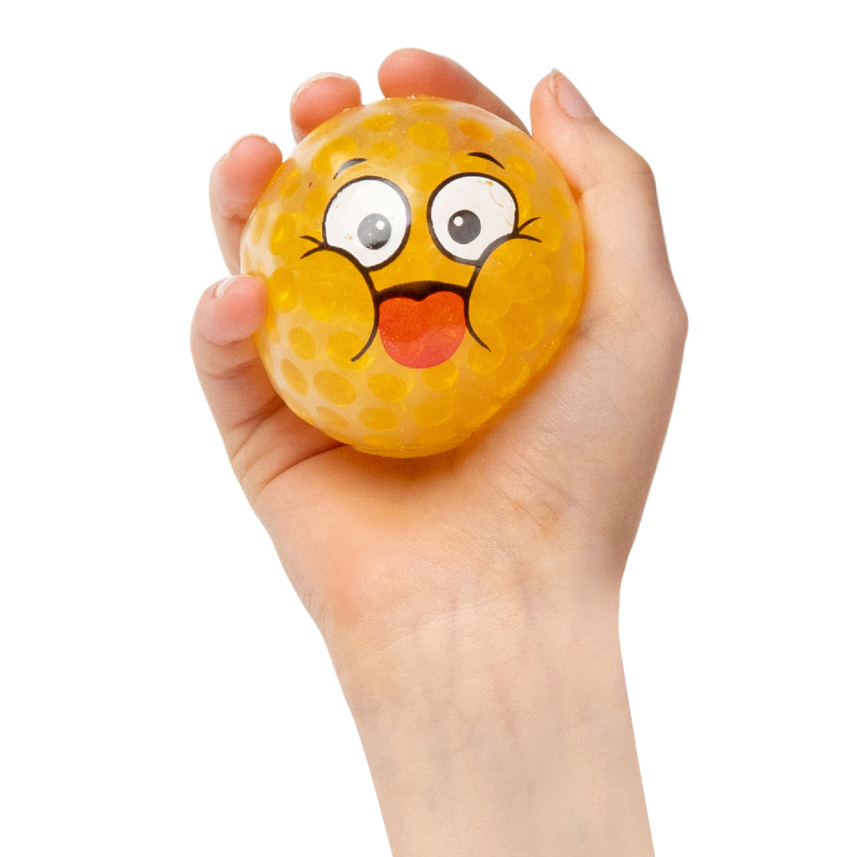 A hand holds a bright yellow textured sensory ball decorated with a cheerful emoji face featuring large expressive eyes, raised eyebrows, and an orange tongue sticking out. The Sensory Sprouts EmotiBall has a dimpled, tactile surface ideal for sensory play and emotional learning activities.